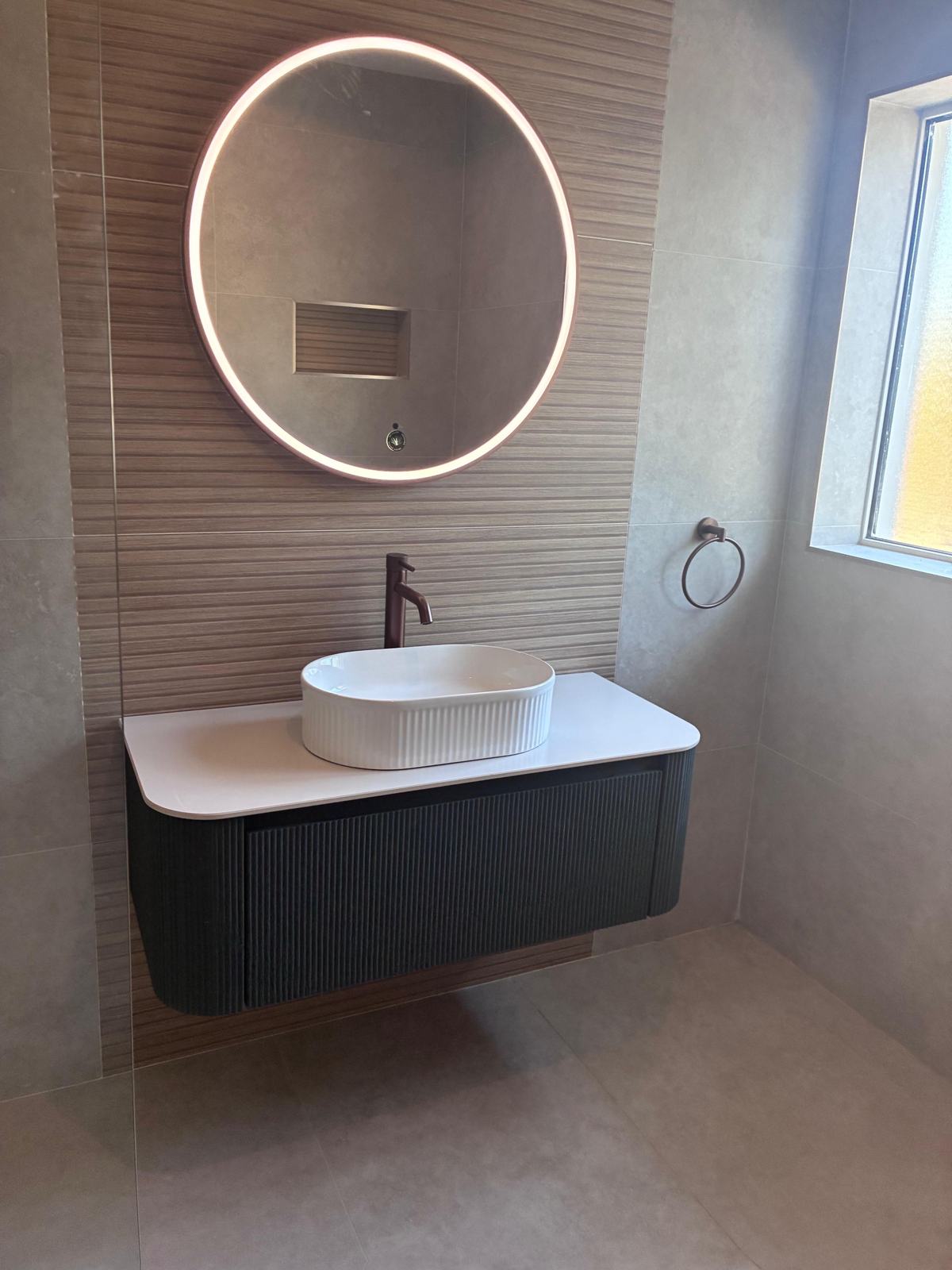 Fluted green vanity with countertop basin and brushed copper tap
